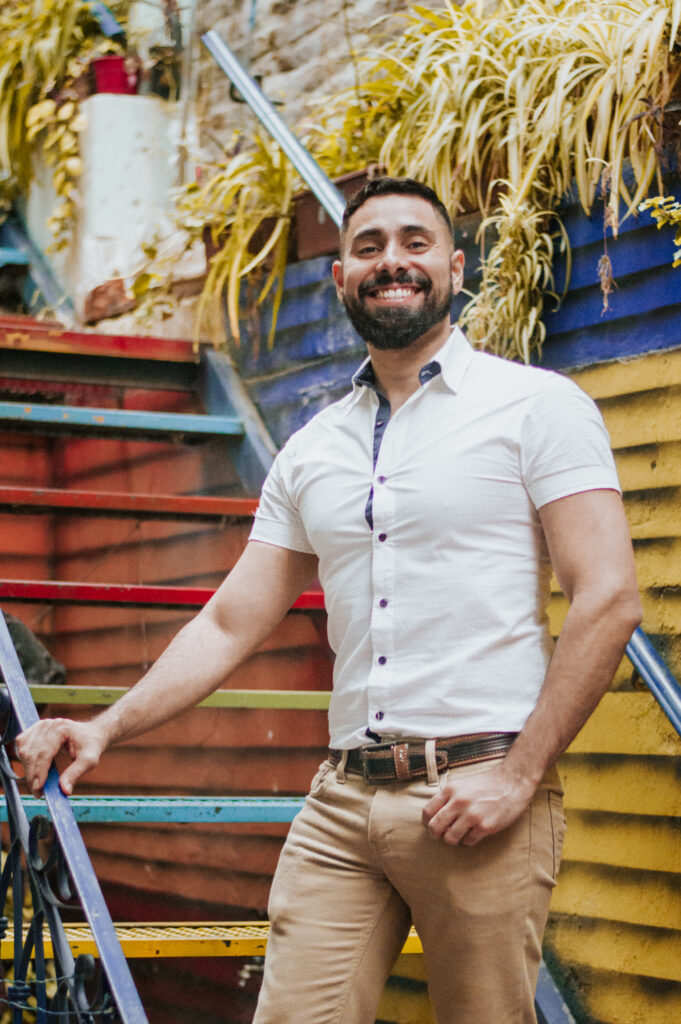 Spanish Inclusive World Founder Junnior standing on the stairs in Argentina. 